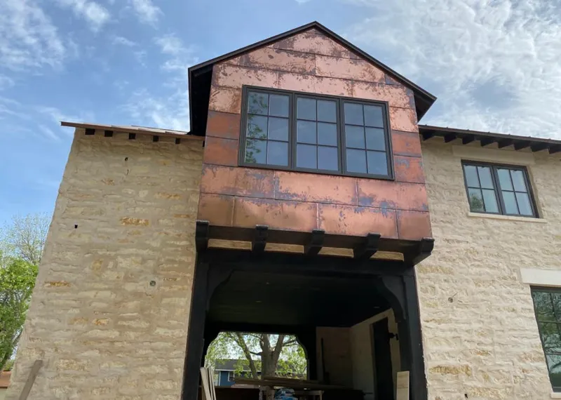 Copper metal panel facade on a stone building for Skylight Installation in Novi
